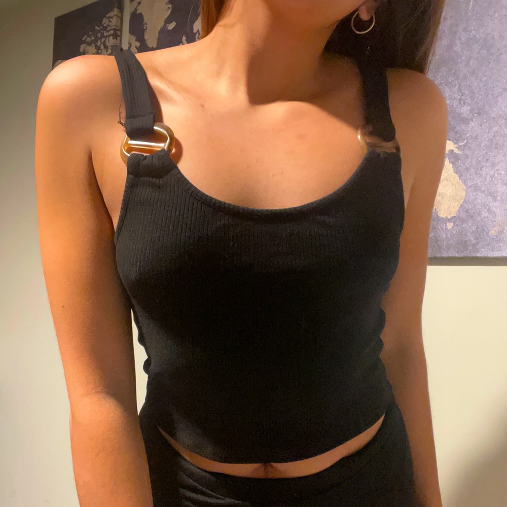 Black tank top with tortoise decor on front part of straps